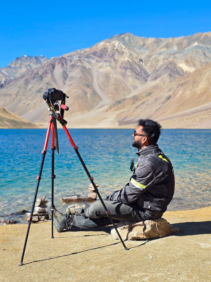 services-01 A photographer enjoys the view at Chandratal Lake in the Himalayas, Himachal Pradesh, India.